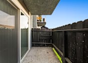Thumbnail 8 of 16 - A balcony with a glass door and a yellow caution tape on the floor.
