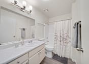 Thumbnail 17 of 17 - A white bathroom with a sink, toilet, and shower.