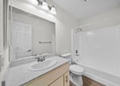 Thumbnail 16 of 16 - A white bathroom with a sink, toilet, and bathtub.