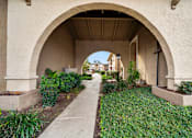 Thumbnail 10 of 16 - A pathway leads through a tunnel of arches.