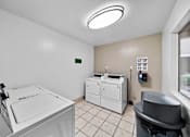 Thumbnail 9 of 16 - A laundry room with a washer and dryer.