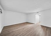 Thumbnail 13 of 16 - A room with wooden flooring and a white ceiling.
