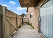 Thumbnail 15 of 16 - A narrow alley with a wooden fence on the left and a concrete wall on the right.
