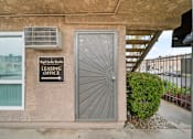 Thumbnail 5 of 18 - A leasing office sign is on the wall of a building.