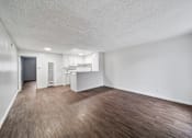 Thumbnail 10 of 18 - A room with a wooden floor and white walls.