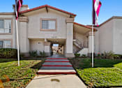 Thumbnail 7 of 10 - A building with a red roof and a flag on a pole.