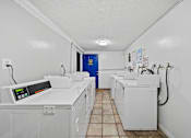 Thumbnail 11 of 11 - A row of washing machines in a laundromat.