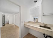 Thumbnail 15 of 21 - A bathroom with a sink and a mirror.