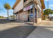 Thumbnail 2 of 21 - A liquor store with a sign that says "Back Liquor".