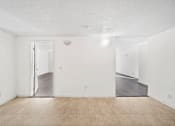 Thumbnail 13 of 21 - A room with a white wall and a wooden floor.