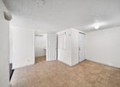 Thumbnail 14 of 21 - A room with white walls and a beige tile floor.