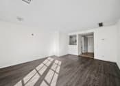 Thumbnail 21 of 21 - A room with wooden floors and white walls.
