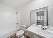 Thumbnail 10 of 10 - A white bathroom with a toilet, sink, and bathtub.