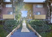 Thumbnail 1 of 10 - A sunny day at the entrance of a residential building.