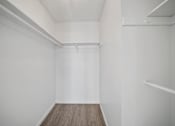 Thumbnail 16 of 16 - A white room with a wooden floor and white walls.