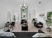 Thumbnail 9 of 16 - A living room with a fireplace and a chandelier.