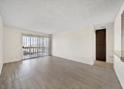 Thumbnail 11 of 16 - A room with a wooden floor and a window with blinds.