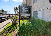 Thumbnail 3 of 11 - A sign for Sherman Pointe Apartments is in front of a building.