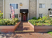 Thumbnail 2 of 11 - The front of a building with a red door and a sign that says "6851".