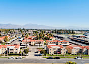 Thumbnail 6 of 6 - A residential area with houses and cars under a clear sky.