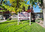 Thumbnail 1 of 16 - A sign for Somerset Townhomes stands in a grassy area.