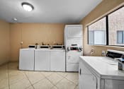 Thumbnail 17 of 20 - A laundry room with a washer and dryer.