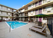Thumbnail 3 of 8 - A pool in a courtyard surrounded by apartment buildings.
