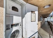 Thumbnail 4 of 4 - A washing machine is installed in a small room.