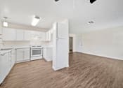 Thumbnail 9 of 13 - A kitchen with white cabinets and a stove top oven.