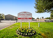 Thumbnail 1 of 9 - A Sterling Estates Apartments sign is in front of a building.