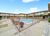 Thumbnail 5 of 15 - A pool surrounded by a fence with a flower pot on it.