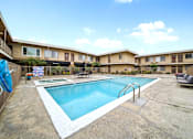 Thumbnail 9 of 15 - A pool in a courtyard surrounded by apartment buildings.