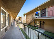 Thumbnail 3 of 9 - A long concrete balcony with a black railing.