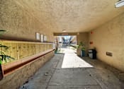 Thumbnail 8 of 9 - A long, narrow hallway with a concrete floor and walls.