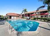 Thumbnail 5 of 8 - A swimming pool in a sunny outdoor setting.