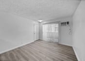 Thumbnail 5 of 8 - A room with a wooden floor and a window with blinds.
