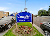 Thumbnail 3 of 12 - The Gondolier Apartments sign with a phone number on it.