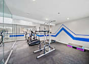 Thumbnail 5 of 12 - A gym with a blue stripe on the wall.