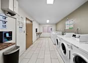 Thumbnail 17 of 20 - A row of washing machines in a laundromat.