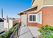 Thumbnail 3 of 14 - A house with a brown wall and a white door is shown.