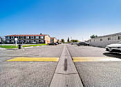 Thumbnail 14 of 14 - A white car is parked on the right side of a street.