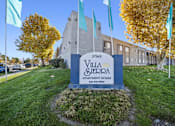 Thumbnail 1 of 14 - Villa Sterpa apartment complex with a sign in front.