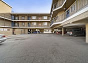 Thumbnail 6 of 14 - A parking garage with cars parked in it.