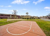 Thumbnail 4 of 18 - A basketball court with a basketball hoop and a basketball net.
