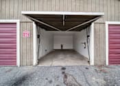 Thumbnail 6 of 18 - A garage with a red door and a sign that says 25.