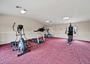 Thumbnail 1 of 18 - A room with a red carpet and exercise equipment.