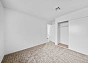 Thumbnail 9 of 11 - A room with carpeted floor and white walls.