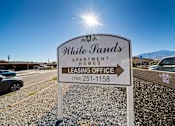 Thumbnail 2 of 11 - A sign for White Pands Apartment Homes with a phone number for the leasing office.
