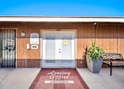 Thumbnail 5 of 11 - A building with a Leasing Office sign on the door mat.