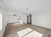 Thumbnail 8 of 11 - A room with a ceiling fan and a rug on the floor.
